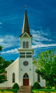 Front view of a church with steeple on a sunny day